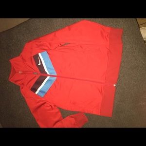 Nike jacket. Size M/10/12. Red with plum,white and blue stripe on front.